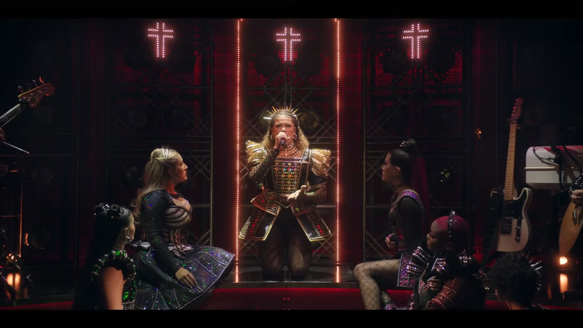 The cast of six poses around Catharine of Aragon during the song "No Way" as the lights of the stage change to imitate a confessional with small crucifixes above Catharine's head.