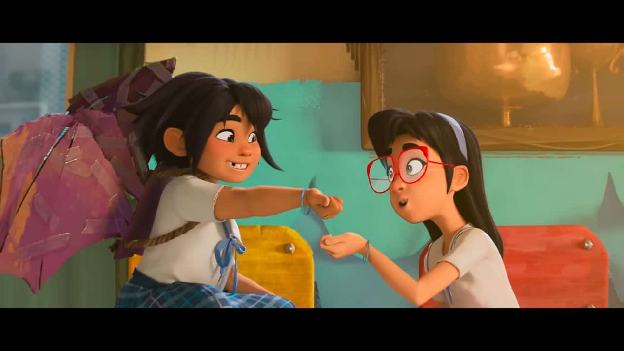 two girls in school uniforms, one wearing homemade bat-like wings and one wearing large-framed glasses sit together outside a principal's office having just exchanged friendship bracelets
